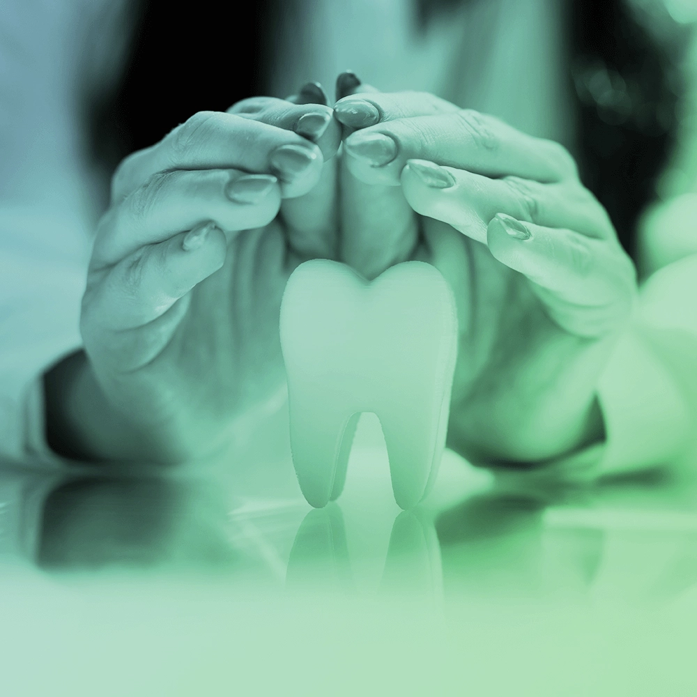 Photo of hand caring for tooth.