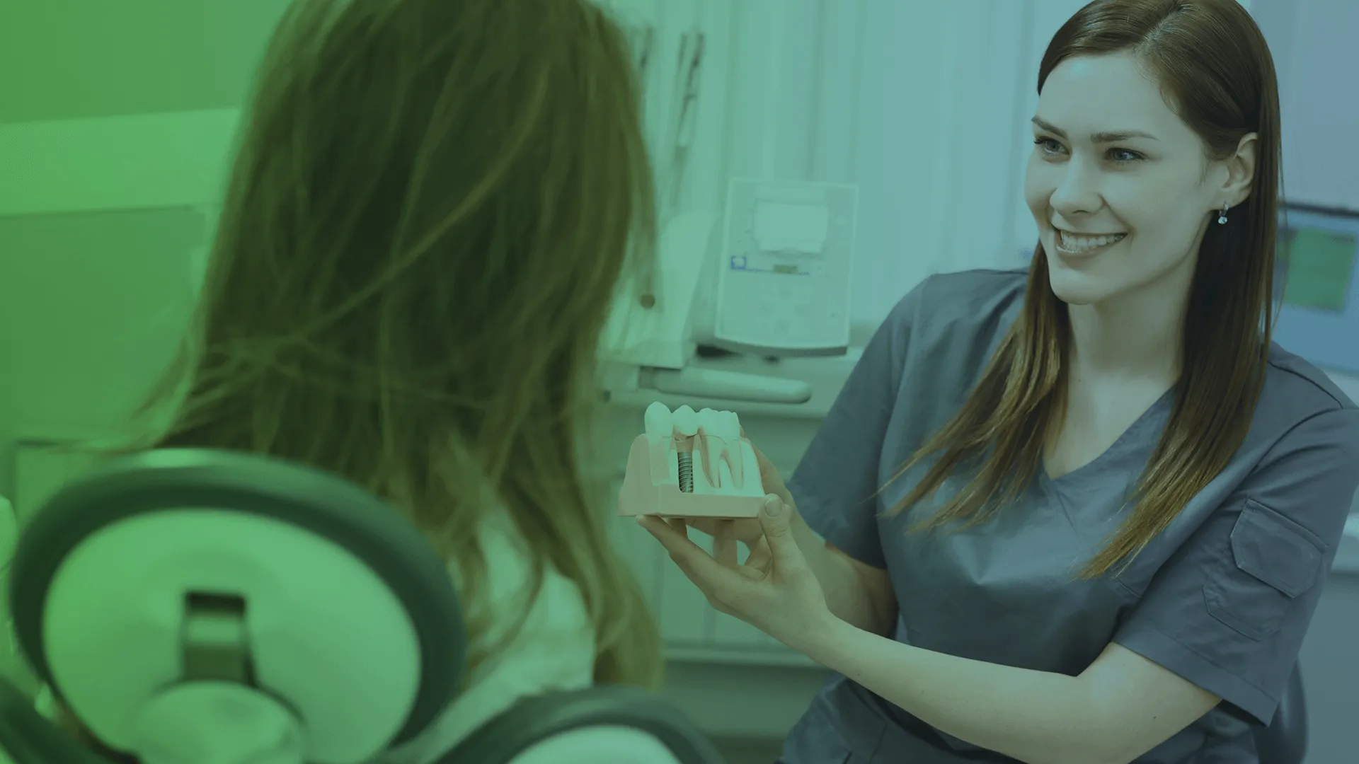 Dentist showing dental implants.