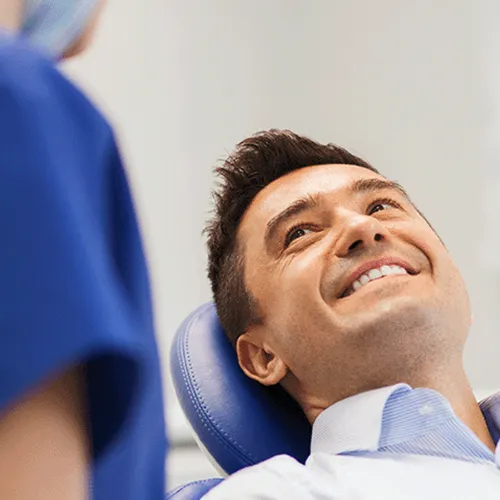 Patient-smiling-up-at-dentist.