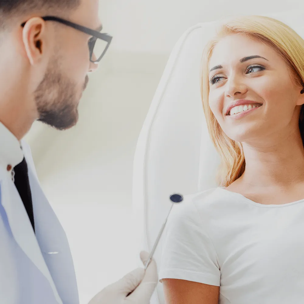 Dentist talking to patient.