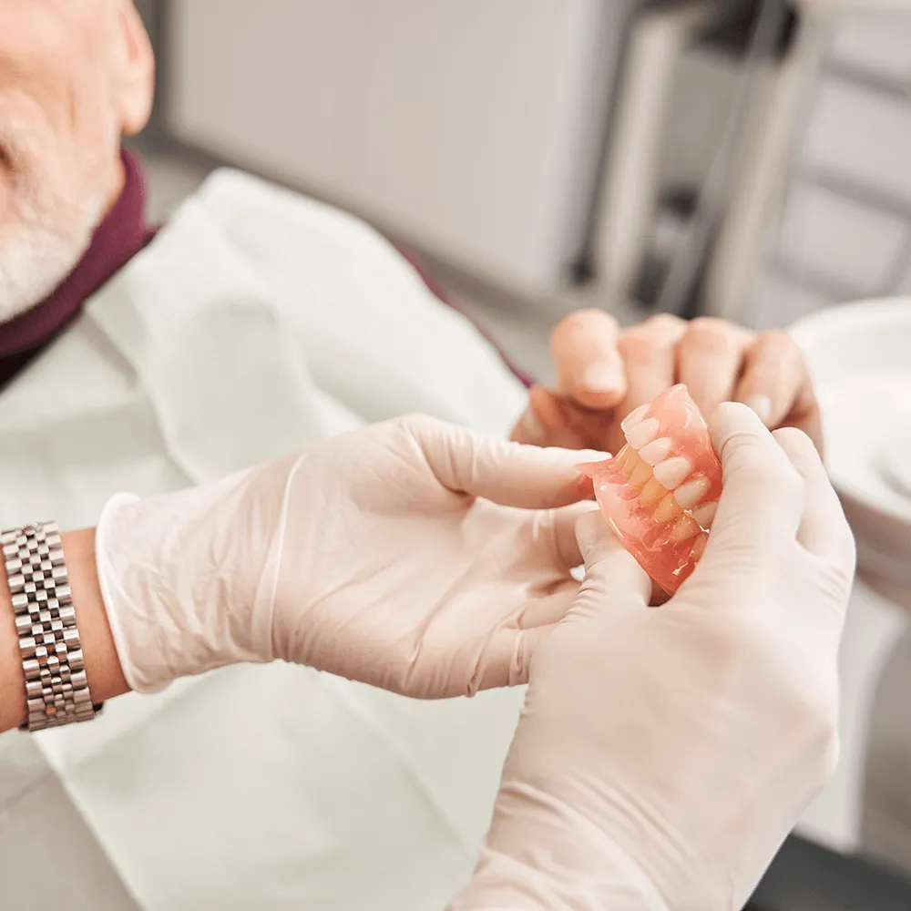 Image of person showing dentures.