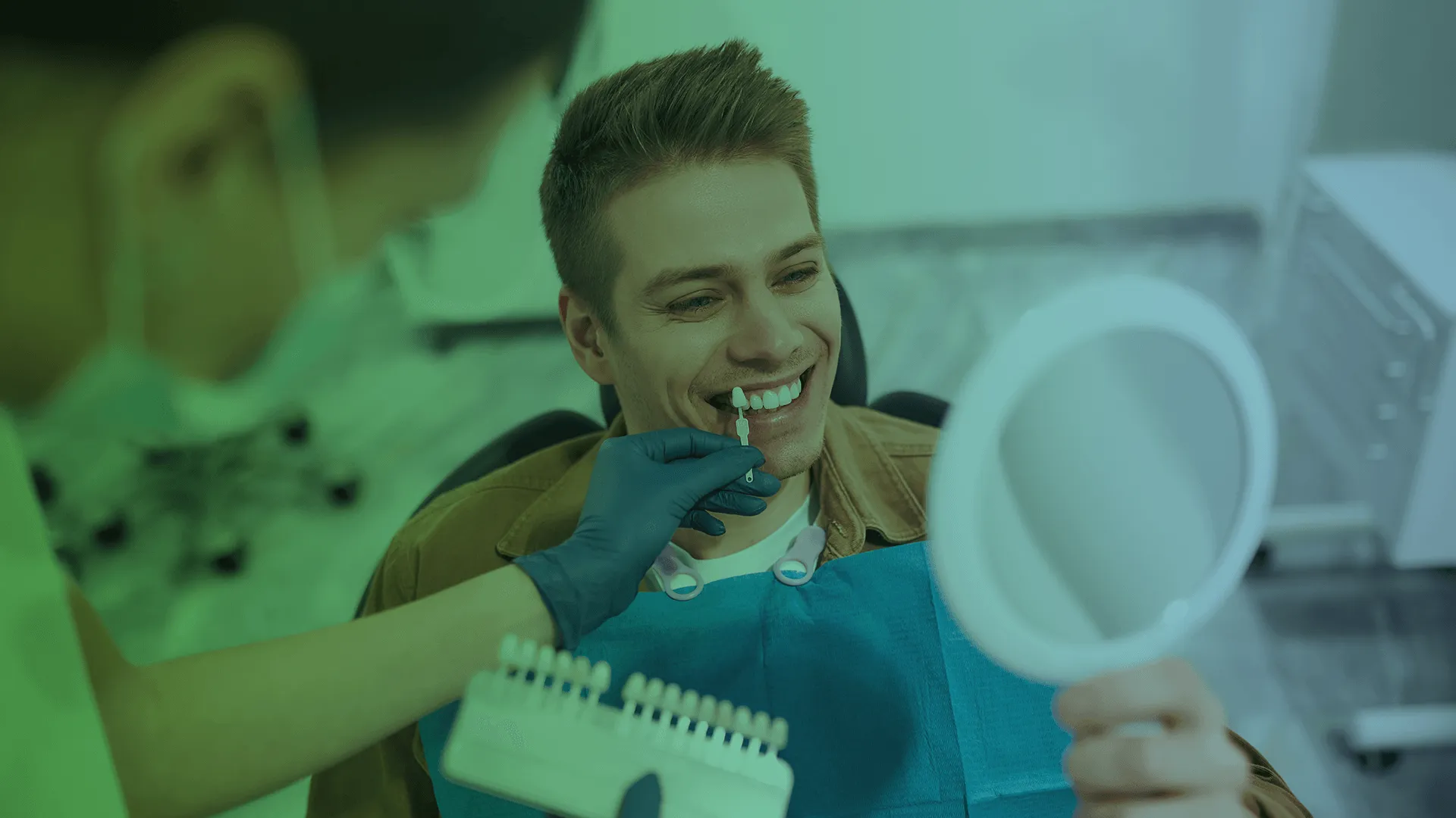 Dentist looking in mirror with veneers held by dentist.