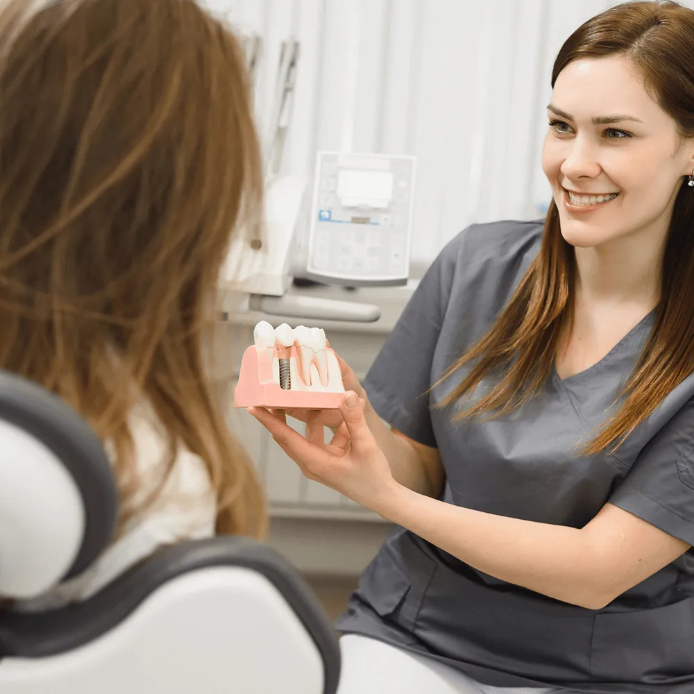 Dentist showing dental implants.