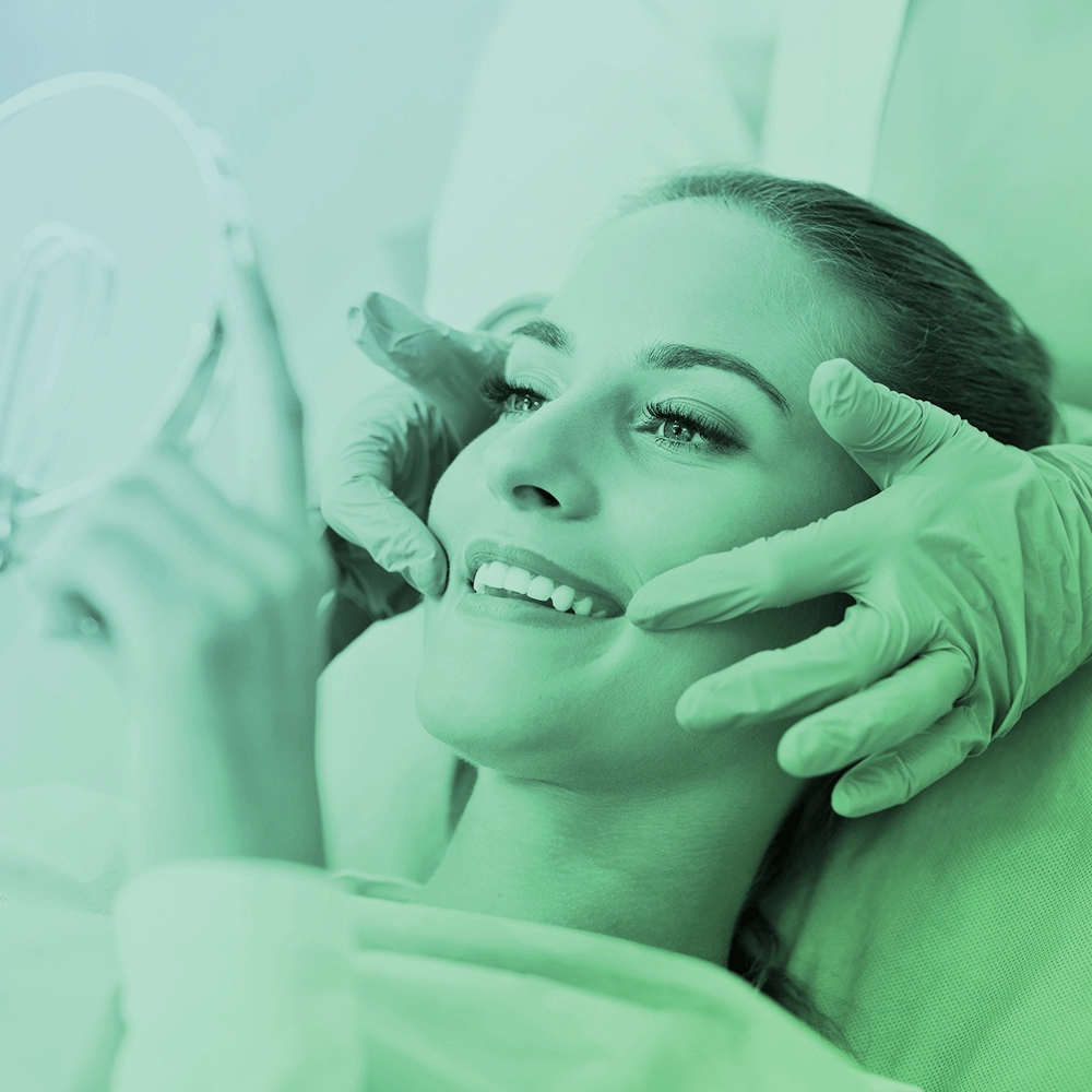 Patient smiling in mirror.